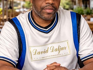 Man wearing a white cap and a shirt with 'David Lafan' printed on it.