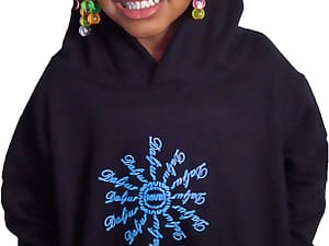 Smiling child wearing a black hoodie with a blue snowflake design.