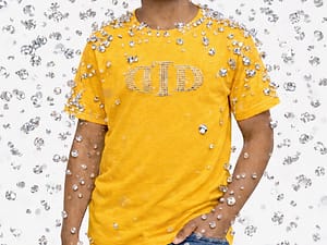 Child in a yellow t-shirt stands amid falling snowflakes.